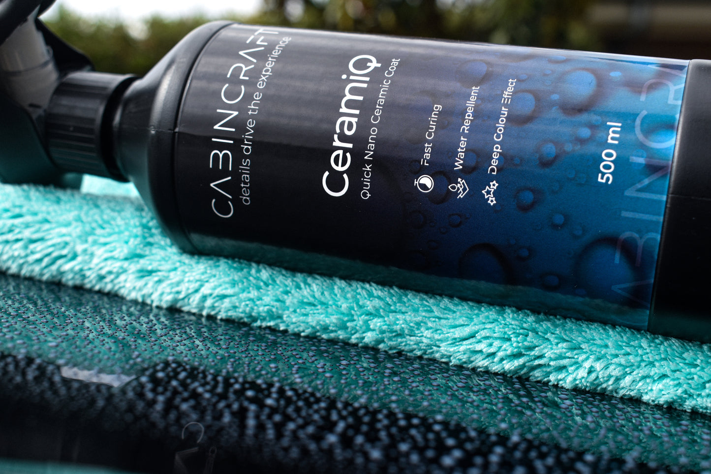 Ceramic coating bottle labeled 'Ceramiq' on a textured surface