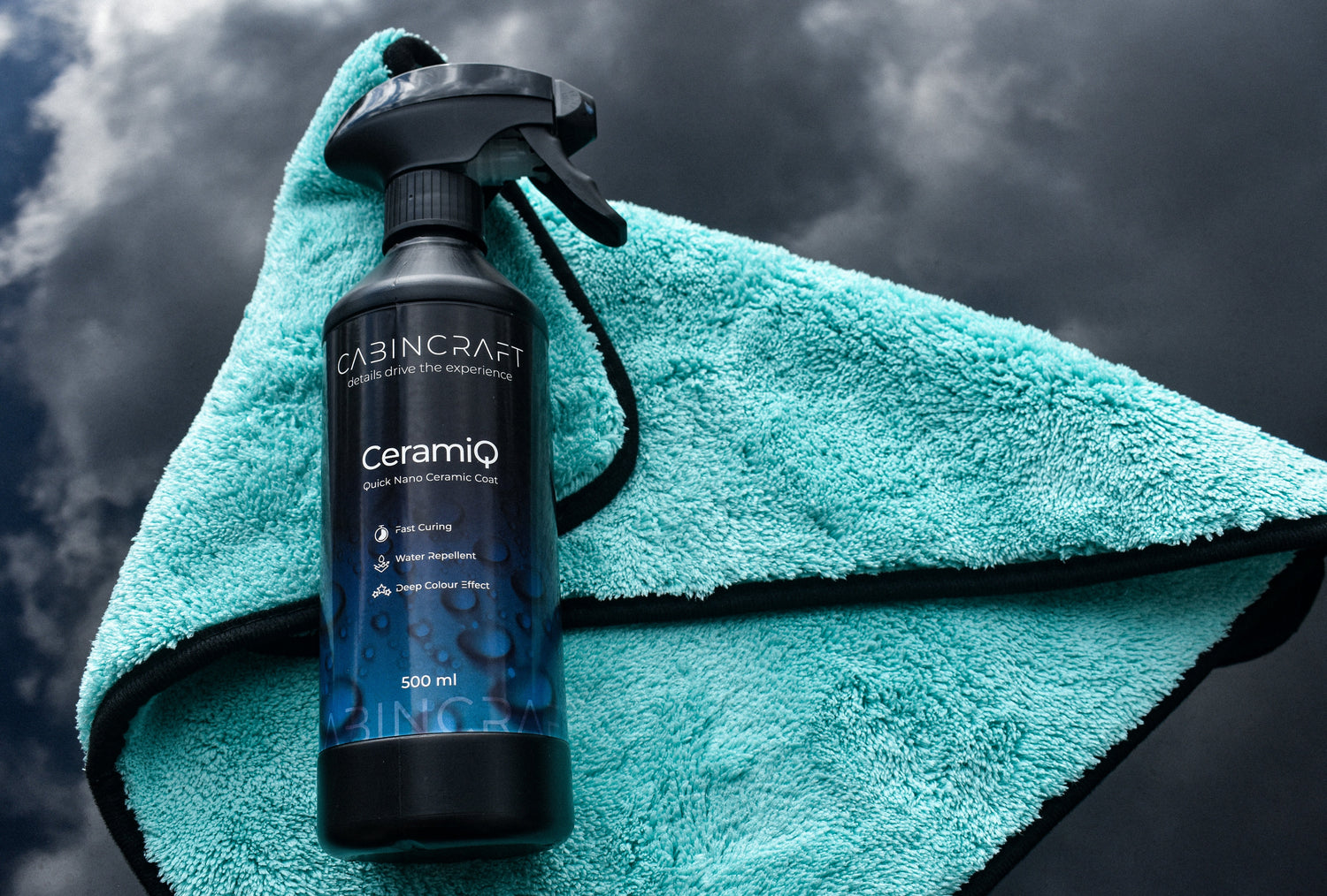 CabinCraft CeramiQ spray bottle on a teal towel against a dark background