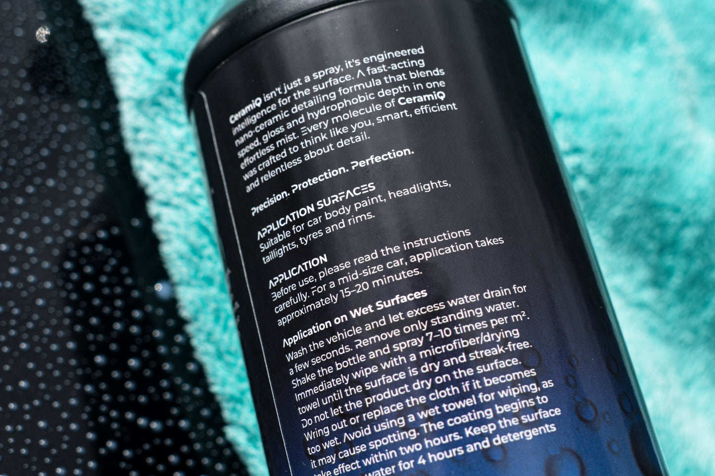 Close-up of a spray can with text on a textured blue surface